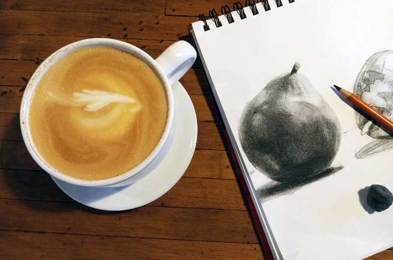 Shading a charcoal pencil drawing of 3 pears.